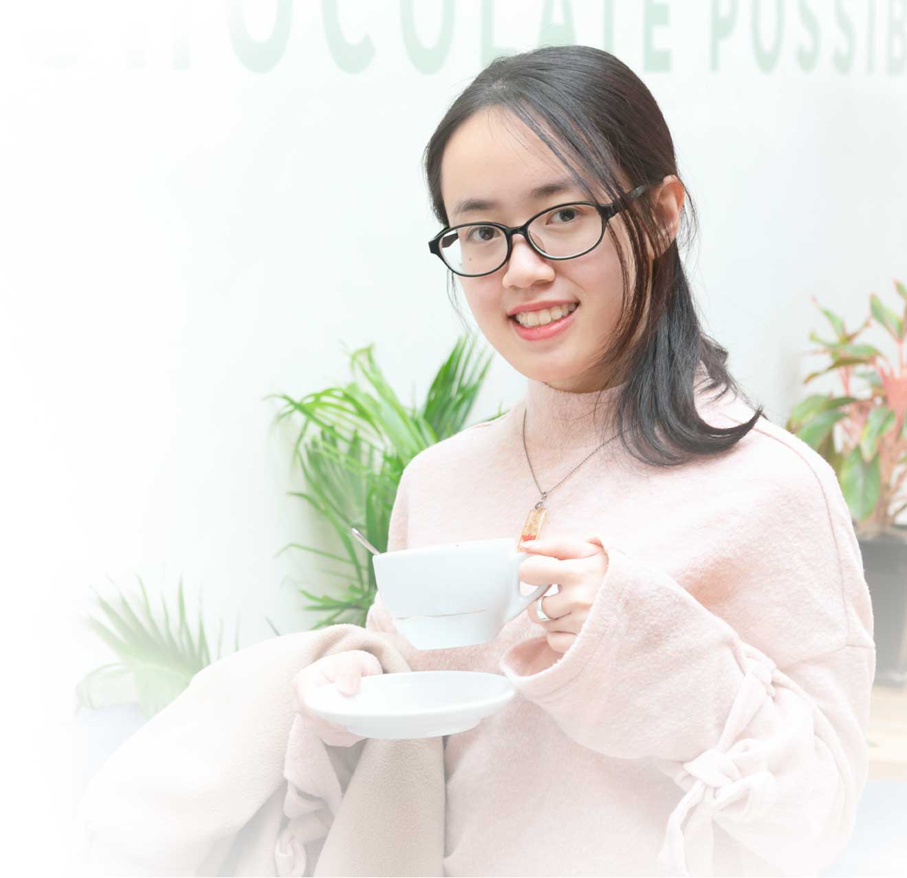 TrangLanguage, certified online Vietnamese tutor smilling happily while holding a cup of coffee